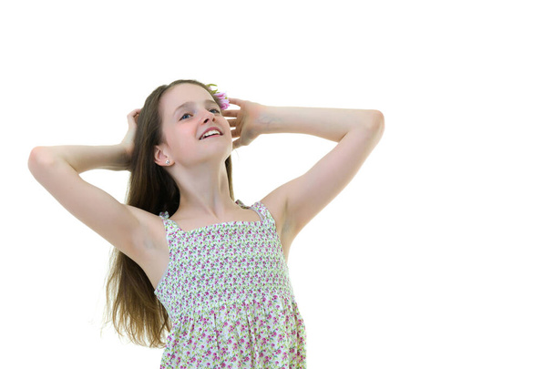 A little girl fixes her hair. - Fotó, kép