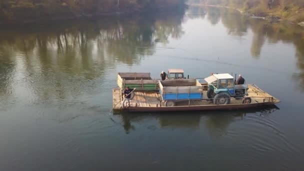 Old manual powered cable ferry for agricultural machinery transport across the river in rural countryside - Footage, Video