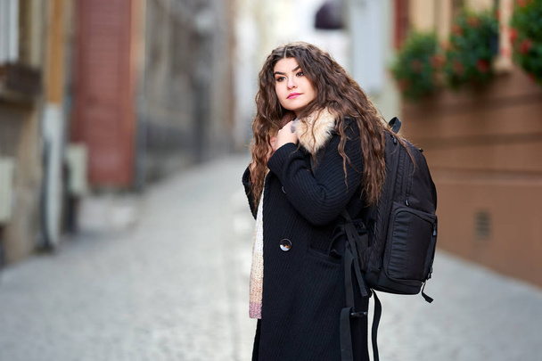 Young woman tourist with backpack in an old town - Photo, image
