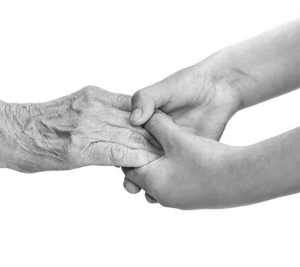 Senior woman and young girl holding hands - Photo, Image