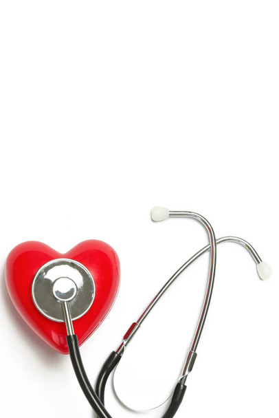 Red heart and a stethoscope isolated on white background - Photo, Image
