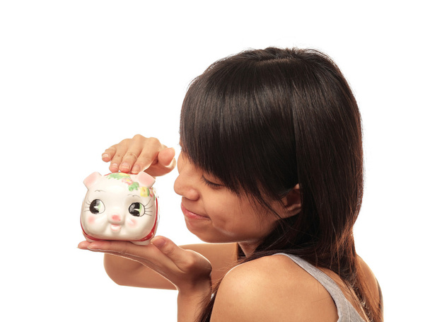 Chinese girl with piggy bank - Фото, зображення