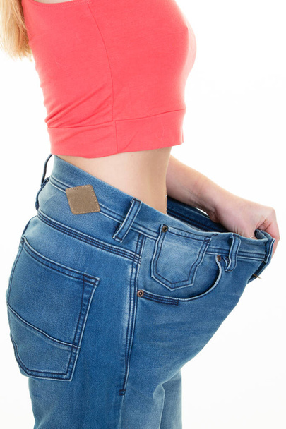 side view unrecognizable young woman In Oversize Pants after diet in Studio Shot - Photo, Image