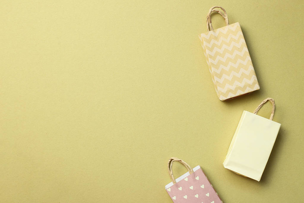 Paper shopping bags on khaki background - Photo, Image