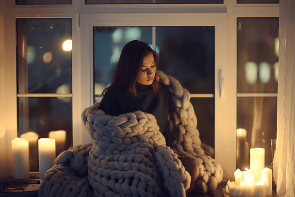 home coziness girl plaid window, home autumn look, model in a warm knitted blanket heats up - Photo, Image