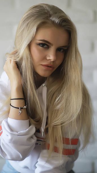 young adult blonde long hair at home, stylish model posing in the studio - Foto, imagen