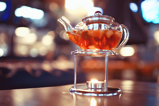 glass transparent teapot tea, cafe tea ceremony, black tea table setting - Фото, изображение
