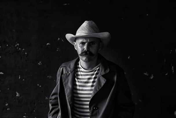 stylized vintage portrait of a man wild west, mustachioed dangerous criminal, mustache on his face - Fotó, kép