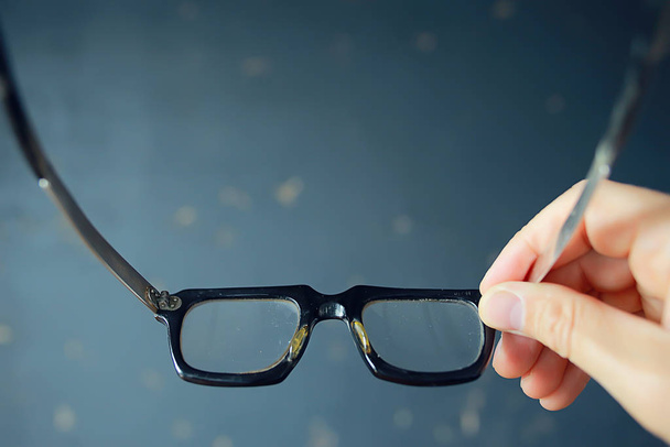 glasses vision concept, man holds glasses in his hand. - Valokuva, kuva