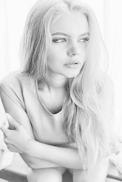 young adult blonde long hair at home, stylish model posing in the studio - Foto, afbeelding