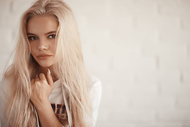 young adult blonde long hair at home, stylish model posing in the studio - Fotoğraf, Görsel