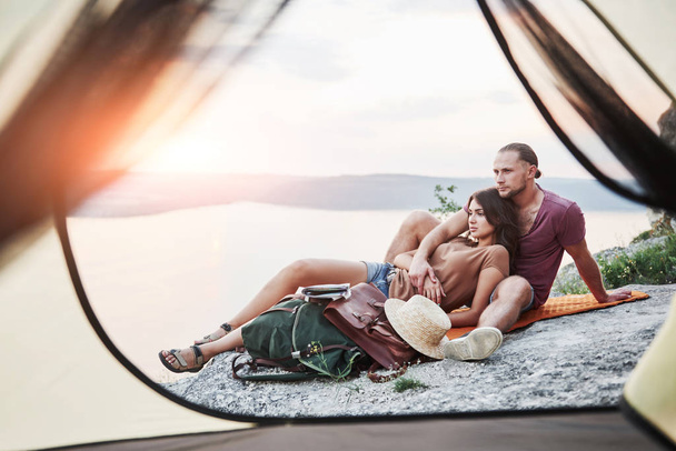 View from tent of couple lying a view of lake during hiking trip. avel Lifestyle concept adventure vacations outdoor. - Fotoğraf, Görsel