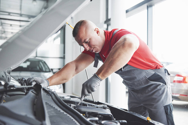 Picture showing muscular car service worker repairing vehicle. - Photo, Image