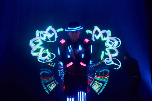 Laser show performance, dancers in led suits with LED lamp, very beautiful night club performance, party. - Photo, Image