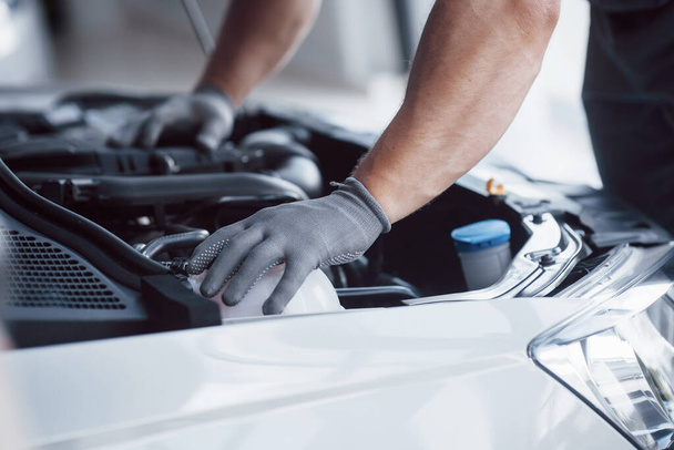 Auto mechanic working in garage. Repair service. - Фото, изображение