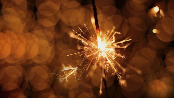 festive sparkler and many sparks macro photo bokeh background Christmas and New Year - Photo, Image