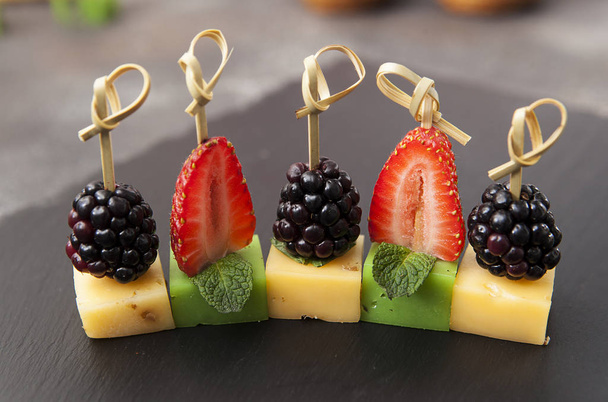 Canapes with cheese and berries. Cheese. Blackberry and strawberry - Φωτογραφία, εικόνα
