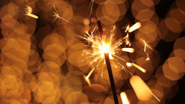 festive sparkler and many sparks macro photo bokeh background Christmas and New Year - Photo, Image