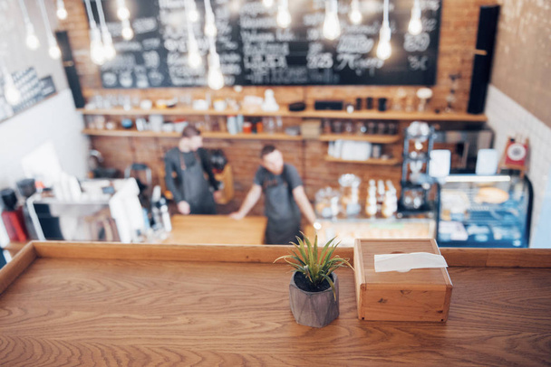 Selective focus image of empty wooden table with blurred coffee shop interior background. image for used display or montage your products. - Foto, Imagem