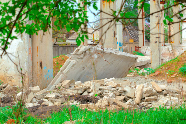 Überreste zerstörter Gebäude, zerbrochener Betonplatten, Pfähle und zerbrochener Ziegel. - Foto, Bild