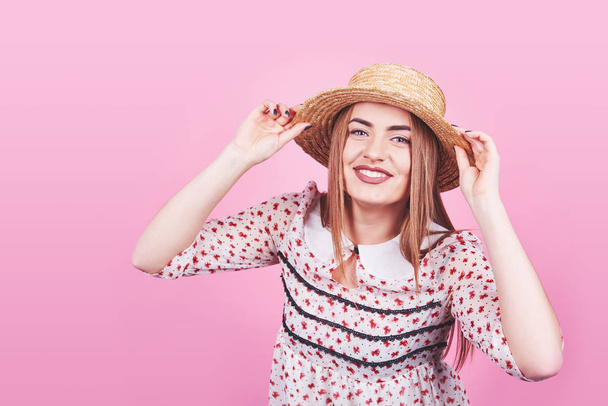 Attractive girl in a white and black stripes, hat, sunglasses, emotionally opened mouth on a bright pink background with a perfect body. Isolated. Studio shot. - Photo, image