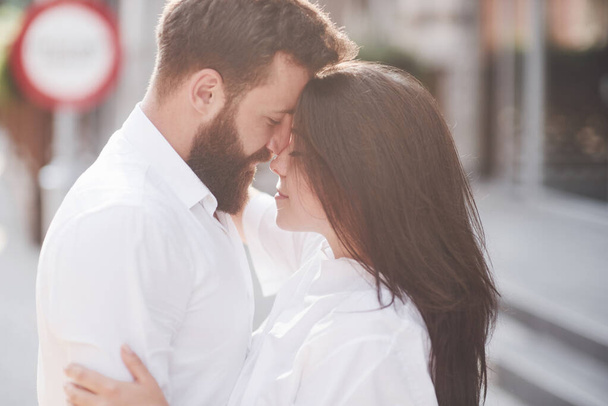 Beautiful happy couple hugging on the city street.Lifestyle concept love and romance. - 写真・画像