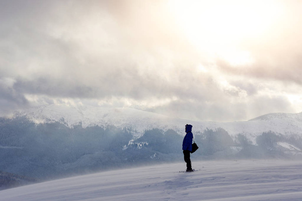 Snowshoe walker running in powder snow with beautiful sunrise light. Outdoor winter activity and healthy lifestyle. - Photo, Image