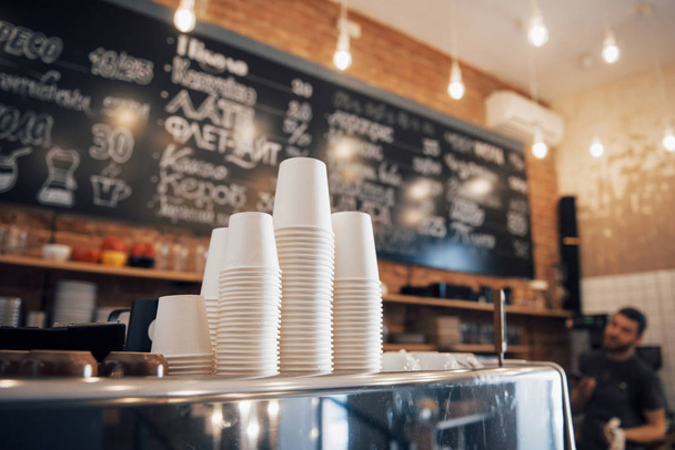 Hipster looking coffee shop ready to open for the day with a clean and tidy counter and well-maintained shiny coffee machine on the the wooden surface. - 写真・画像