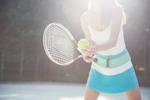A pretty woman wearing a sportswear tennis court on the court. - Foto, Imagen