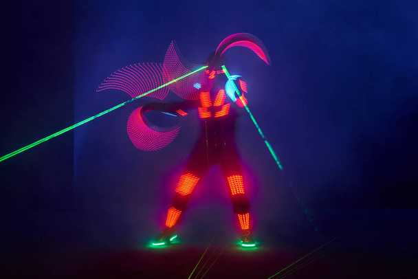Laser show performance, dancers in led suits with LED lamp, very beautiful night club performance, party. - Fotoğraf, Görsel