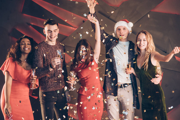 Air in the confetti. Five good friends in the good clothes are on the party of new year. - Фото, зображення