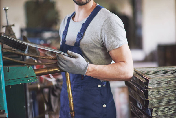 Portrait of a young master working at a factory - Foto, Bild