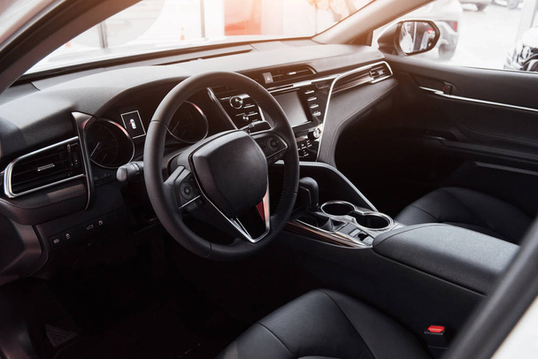 View of the interior of a modern automobile showing the dashboard. - 写真・画像