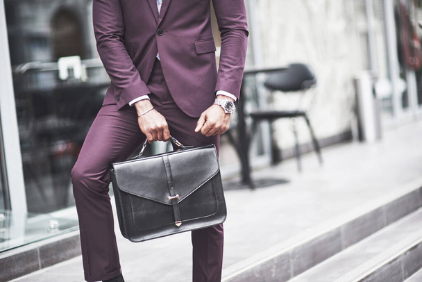 Young businessman with a briefcase near a beautiful office. Business meeting - Fotó, kép