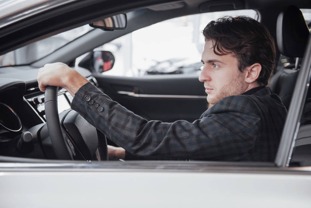 Ready for test drive. Portrait of a handsome businessman driving car. - Foto, Imagen