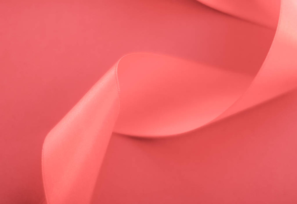 Abstract curly silk ribbon on coral background, exclusive luxury - Photo, Image