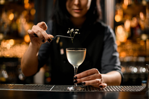 Close-up of bartender adding small branch in cocktail - Фото, изображение
