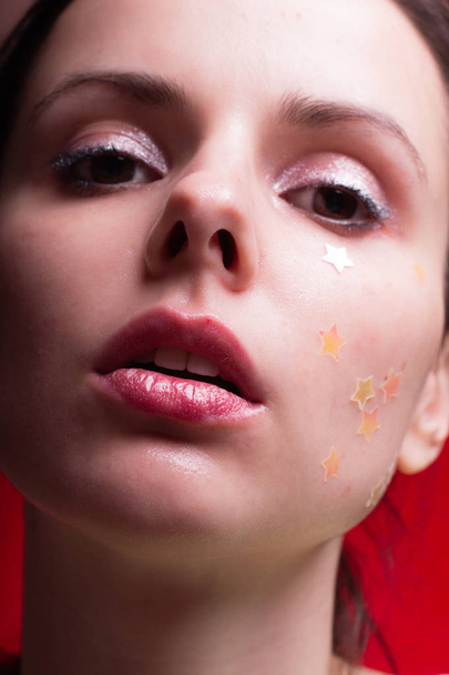 beautiful girl with sparkles on her face, close-up portrait - Φωτογραφία, εικόνα