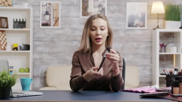 Stylish beauty influencer recording a makeup tutorial - Filmati, video