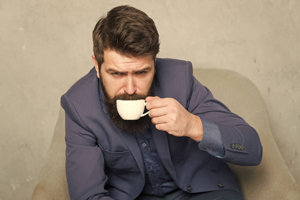 Man handsome bearded businessman hold cup of coffee. Coffee break concept. Business people. Best coffee served for him. Attractive pensive manager in thoughtful mood. Coffee cup. Recharge and reload - Foto, afbeelding