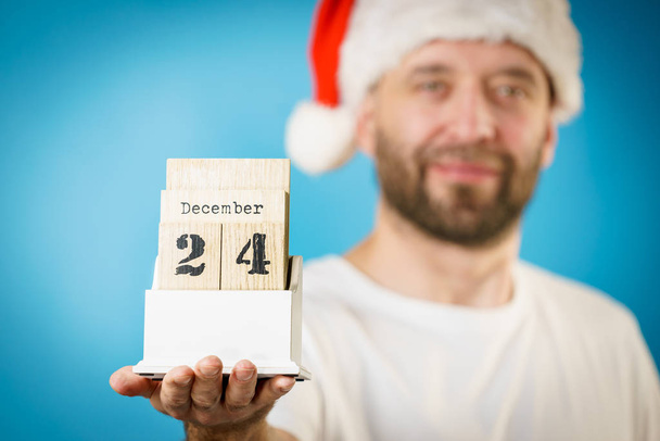 December 24th. Man santa hat holds calender - Photo, image