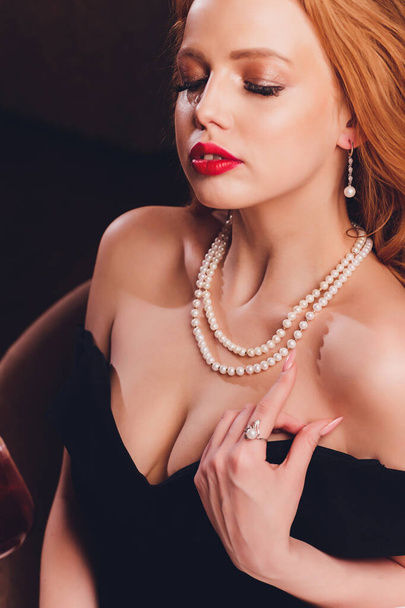 elegant young woman with jewelry at restaurant. - Foto, afbeelding