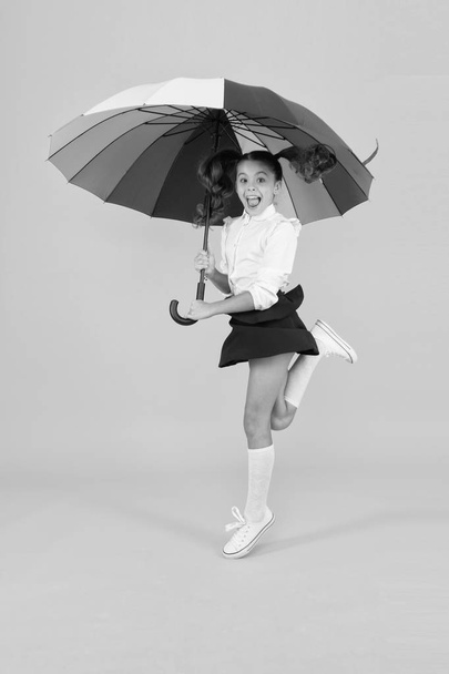 School time. Rainbow style. Colorful life. Schoolgirl happy with umbrella. Fall weather forecast. Fashion accessory. Umbrella protective shield. Girl with umbrella. Rainy day walks. Happy childhood - Φωτογραφία, εικόνα