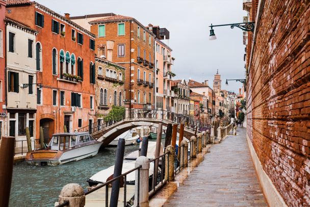 Kanal, Vaporetto in der Nähe einer Brücke und eines antiken Gebäudes in Venedig, Italien  - Foto, Bild