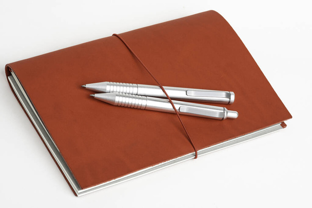 Red Leather Journal Cover with Two Ballpoint Pens
 - Фото, изображение