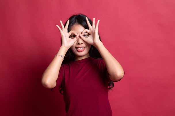 Asian woman do funny  double OK sign as glasses. - Фото, изображение