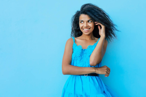 dreaming young afro-american girl on blue background  - Fotoğraf, Görsel