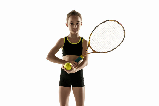 Little caucasian girl playing tennis isolated on white background - Zdjęcie, obraz