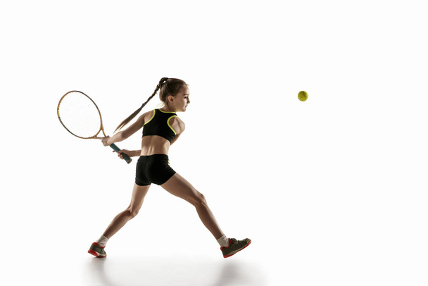 Little caucasian girl playing tennis isolated on white background - Φωτογραφία, εικόνα