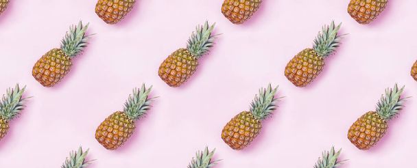 Creative food pattern with pineapples on pink backgound. - Фото, изображение